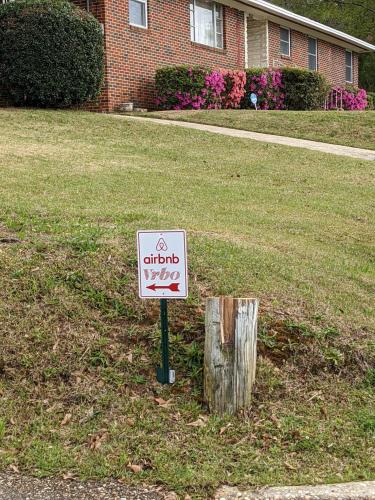 a sign in the grass in front of a house at Historic House on the HillDownstairs ONLY in Tuskegee