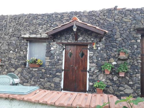 a stone building with a wooden door and a window at B&B Domo De Pedra in Tottubella