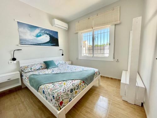 a bedroom with a bed and a window at Villa Escaleta Costa dorada piscina salina y privada,barbacoa in Les tres Cales
