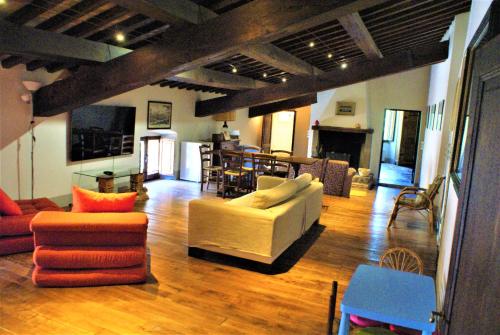 a living room with couches and chairs and a table at Relais La Torre in Chiassa Superiore