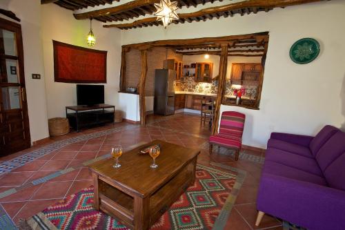 a living room with a couch and a table at Casa Carole - 3 Bedroom Luxury Apartment in Bubión