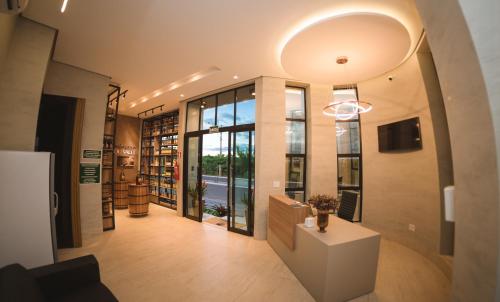 a hallway of a library with a large window at Hotel Du Valle - Salinas - MG in Salinas