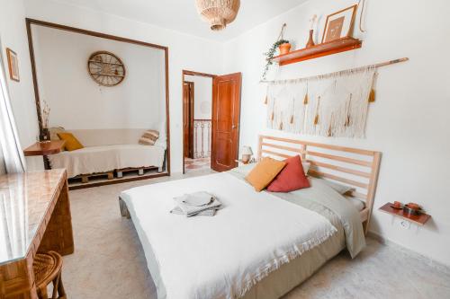 a bedroom with a bed and a mirror in it at LemonTree Eco Surfhouse in Sagres