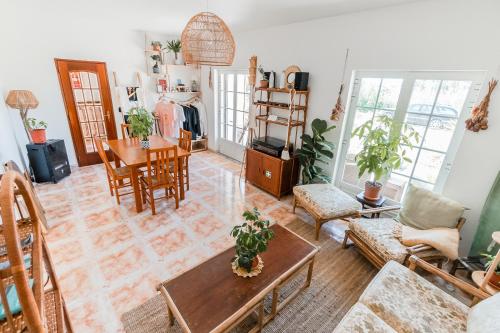 a living room with a table and chairs at LemonTree Eco Surfhouse in Sagres