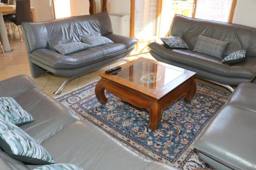a living room with couches and a coffee table at Chalet Savoyard Balcon de Villy in Étaux