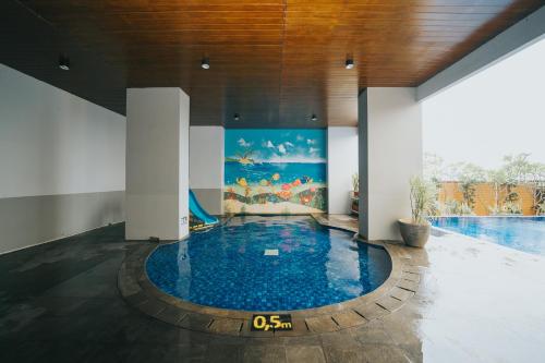 a pool in a building with a swimming pool at Tmansari Mahogany by SCT in Badami