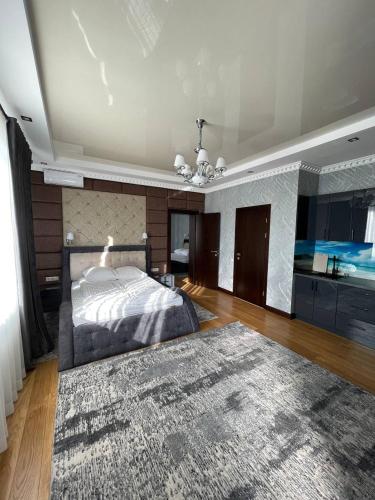 a large bedroom with a bed and a rug at Hotel Ashad in Svalyava