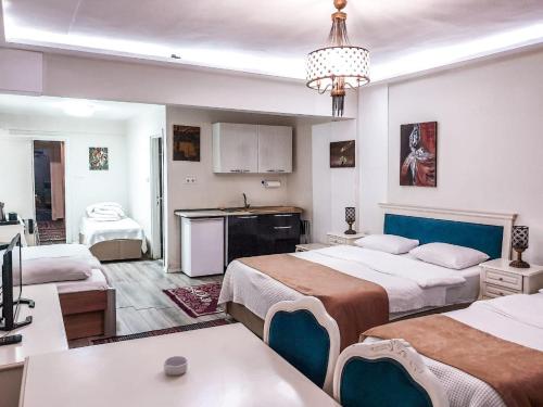 a hotel room with two beds and a kitchen at 1453Apartments in Istanbul
