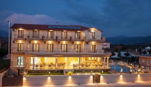 un gran edificio con una piscina frente a él en Aktaia Boutique Hotel, en Ammoudia