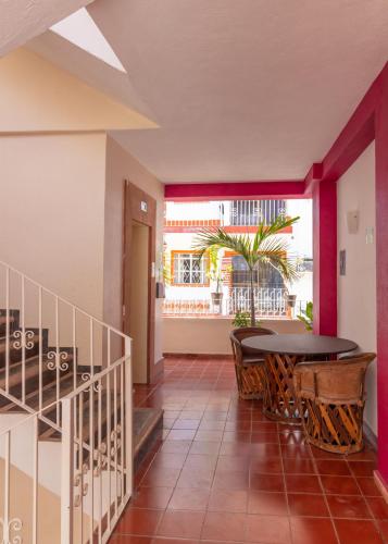 a hallway with a table and chairs and a balcony at Suites Plaza del Rio - Family Hotel Malecón Centro in Puerto Vallarta