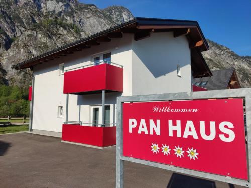 a sign in front of a house with a pan haus at Pan Haus Bad Goisern in Bad Goisern