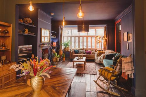 a living room with a table and a couch at Ballarat House in Margate