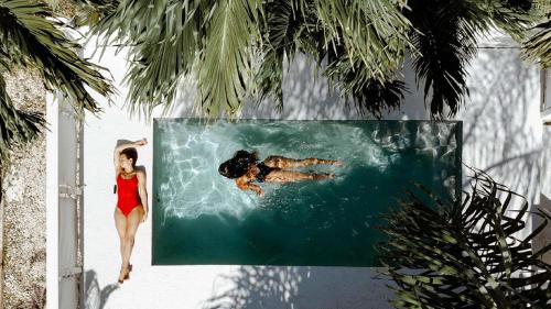 una mujer en bikini rojo nadando en el agua en Casa Loba Suite 4 with private pool, en Rincón