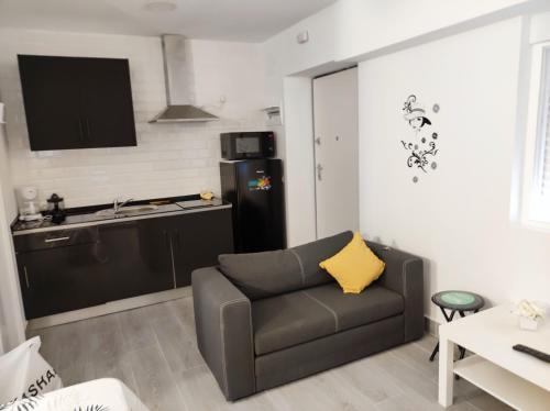 a living room with a couch and a kitchen at LOFTS ARENAL in Madrid