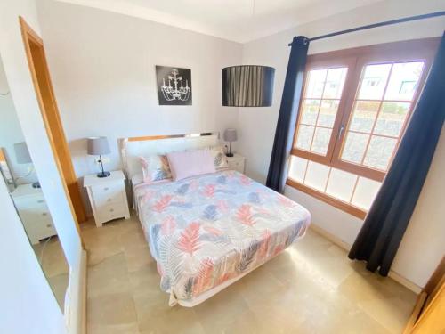 una piccola camera da letto con un letto e una finestra di Villa Sea Breeze Ocean View a Playa Blanca