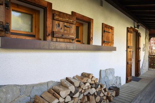 a pile of fire wood next to a building at Chalet Belle-Sofianna in Saint-Gervais-les-Bains