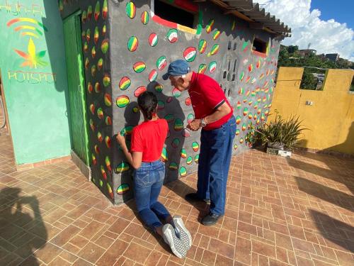 a man and a woman standing next to a climbing wall at Hotel Hostal El Castillo Santa in Santa Bárbara