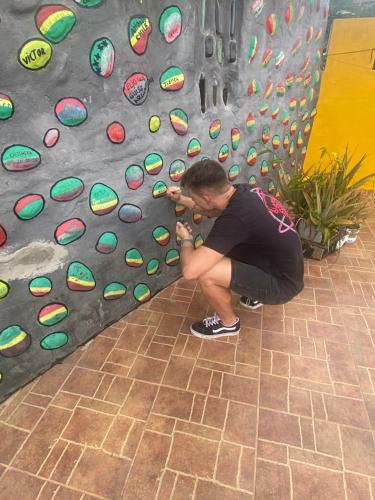a man is climbing a rock wall at Hotel Hostal El Castillo Santa in Santa Bárbara