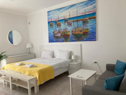 a bedroom with a bed and a painting of boats at Matera Villa Mater in Matera