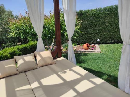 a couch sitting in front of a window at Villa Traditional Estate Heated Pool & Garden, 5 bedrooms in Metókhion Patriotikón