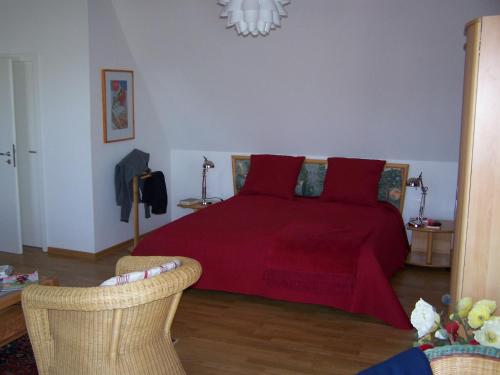 a bedroom with a large bed with red pillows at Meerblick Heringsdorf in Heringsdorf