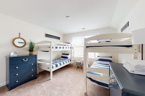 a bedroom with two bunk beds and a desk at Millville by the Sea- 23923 Pembroke Lane in Millville