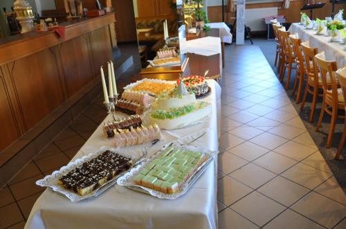 a table with many different types of cakes and pastries at Hotel Elxleben in Elxleben