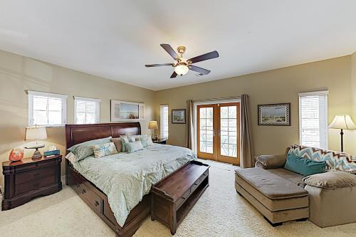 a bedroom with a bed and a ceiling fan at Westwood House in Oceanside