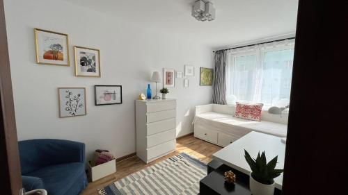 a living room with a couch and a window at Sunrise apartment in Bistriţa
