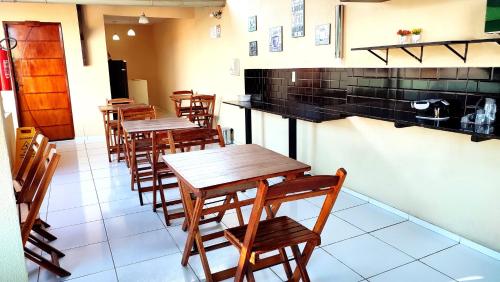 a row of tables and chairs in a restaurant at Hotel Pinto Martins in Camocim