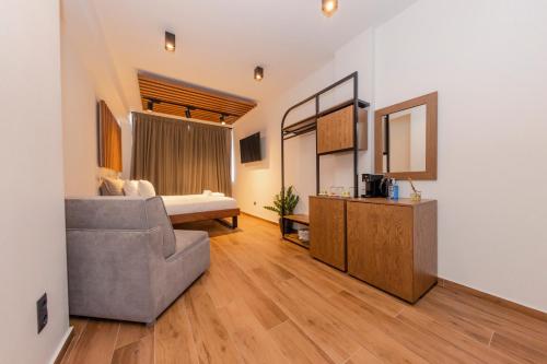 a living room with a couch and a bed at Centrally Stylish Suite by Acropolis in Athens