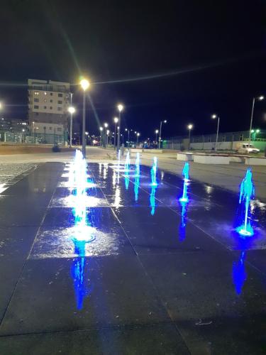 a group of blue lights in a parking lot at night at Apartman RIM in Lukavica