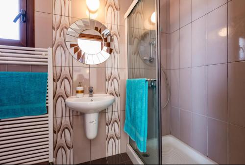 a bathroom with a sink and a mirror and a shower at SunShine Villa Paphos in Nicosia