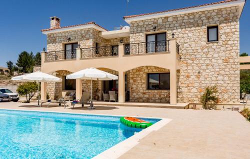 a villa with a swimming pool in front of a house at SunShine Villa Paphos in Nicosia