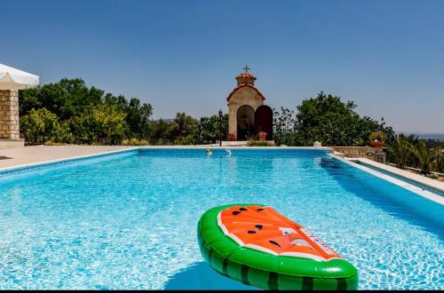 a swimming pool with a inflatable toy in the water at SunShine Villa Paphos in Nicosia
