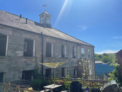 an old stone building with a cross on top of it at 2-Bed Flat in Summerbridge Harrogate Pet Friendly in Harrogate