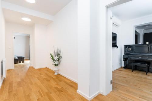 a living room with a piano and a wooden floor at Apartmán Ondřejská 2159 Karlovy Vary in Karlovy Vary