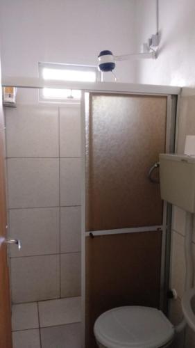a bathroom with a toilet and a shower with a light at CASA De MÃE - CAMPINA GRANDE in Campina Grande