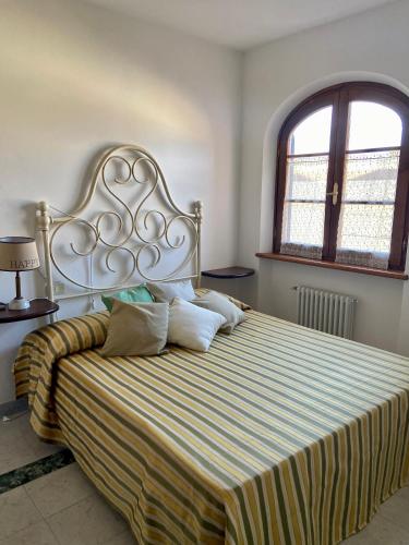 a bedroom with a large bed with a striped blanket at Villa Silvana in Querceta
