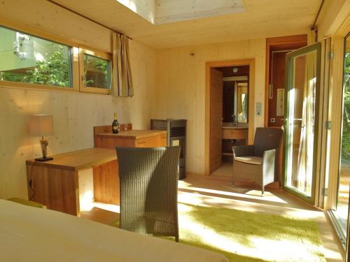 a living room with a table and chairs at Baumhaus Lodge Schrems in Schrems