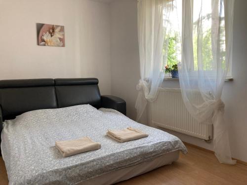 a bedroom with a bed with two towels on it at Dom Chotomów in Chotomów