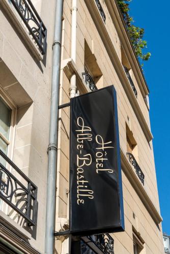 a black sign on the side of a building at Hotel Albe Bastille in Paris