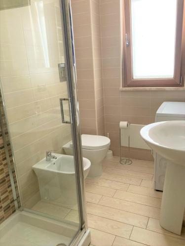 a bathroom with a toilet and a sink and a shower at La Casa del Mare in Sperlonga