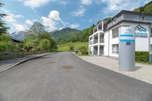 an empty street in front of a white building at Finest Apartments Glacier View by All in One Apartments in Kaprun