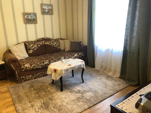 a living room with a couch and a table at Posti Old Town Apartment in Viljandi