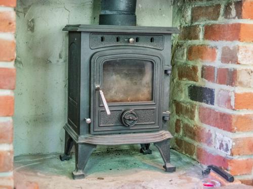 an old wood stove in a brick wall at Endymion in Fritham