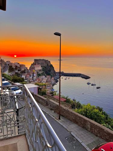 a sunset over a city with boats in the water at Nel blu dipinto di blu in Scilla