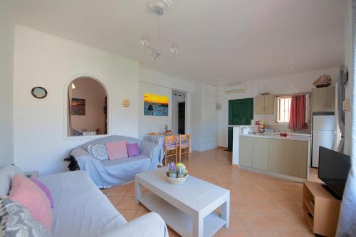 a living room with a couch and a table at Calliope Paradise Balcony in Panormos Kalymnos