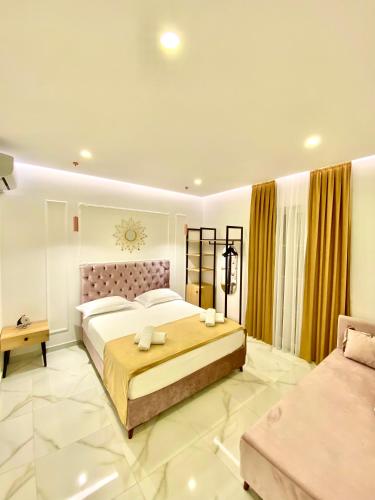 a bedroom with a large bed and a couch at Apartments Oda Hotel in Velipojë