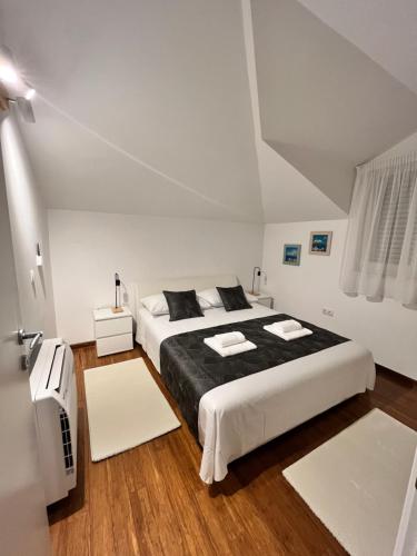 a bedroom with a large bed with black sheets at SKY - beautiful rooftop apartment with shared pool in Split
